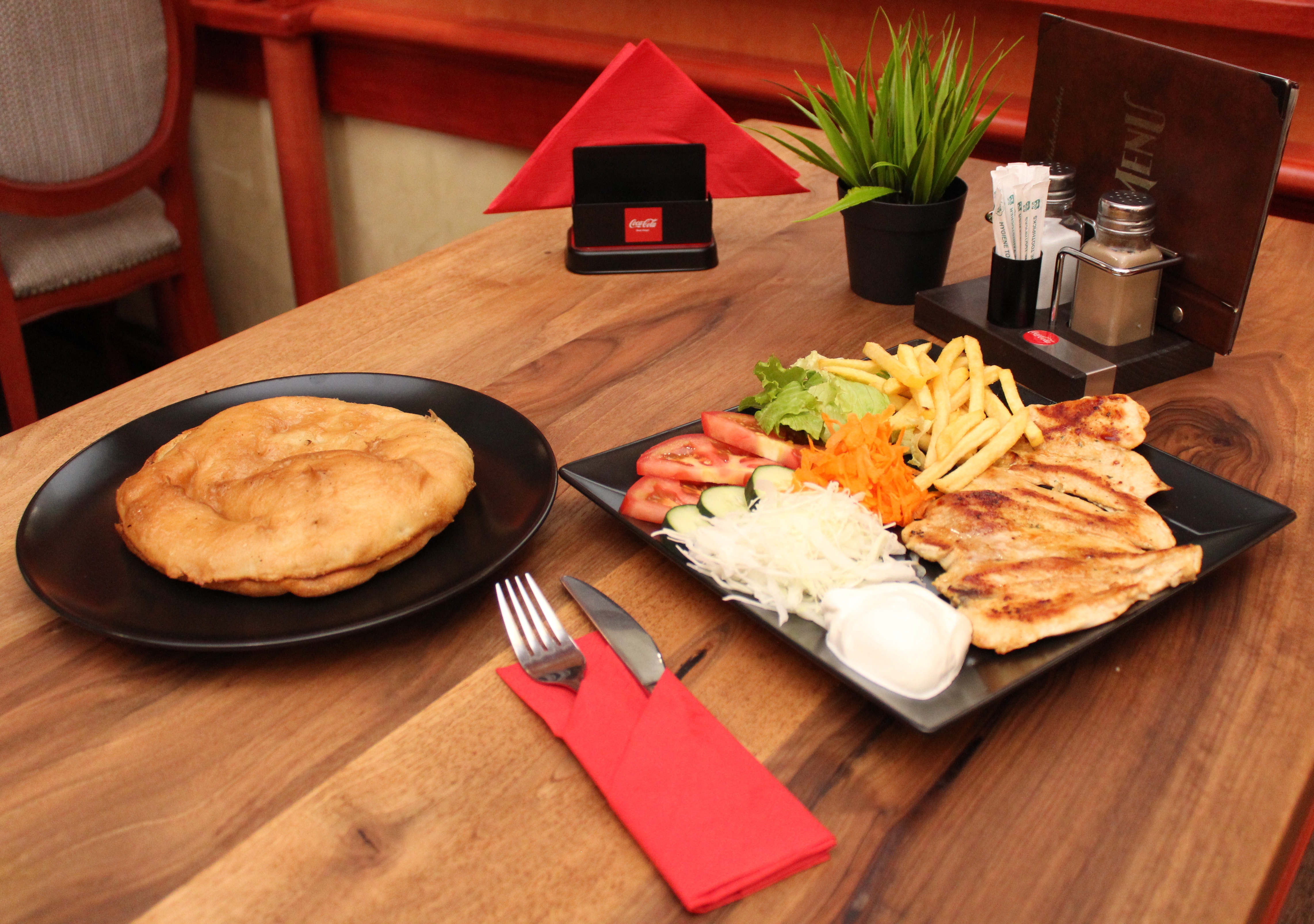Grilled chicken steak with fries and salad